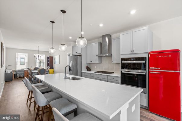 Chandelier, Dining room, Interior, Kitchen, Pendant Lights, Recessed Lighting, Stainless Steel Appliances, Wood Texture Flooring