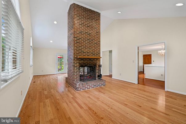 Chandelier, Empty room, Fireplace, Interior, Recessed Lighting, Stone Walls, Wood Texture Flooring