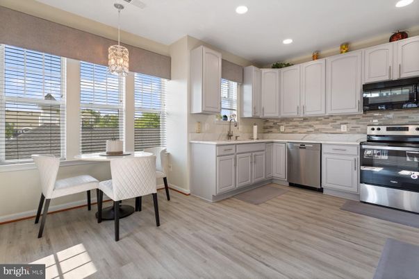 Chandelier, Dining room, Interior, Kitchen, Pendant Lights, Recessed Lighting, Stainless Steel Appliances, Wood Texture Flooring