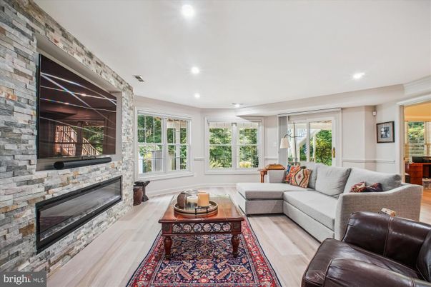 Fireplace, Interior, Living room, Recessed Lighting, Stone Walls, Wood Texture Flooring