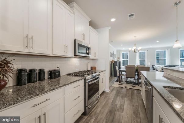 Chandelier, Dining room, Interior, Kitchen, Pendant Lights, Recessed Lighting, Stainless Steel Appliances, Wood Texture Flooring
