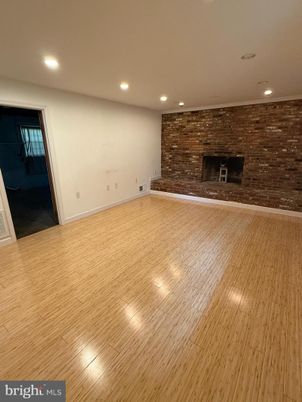 Empty room, Fireplace, Interior, Recessed Lighting, Stone Walls, Wood Texture Flooring