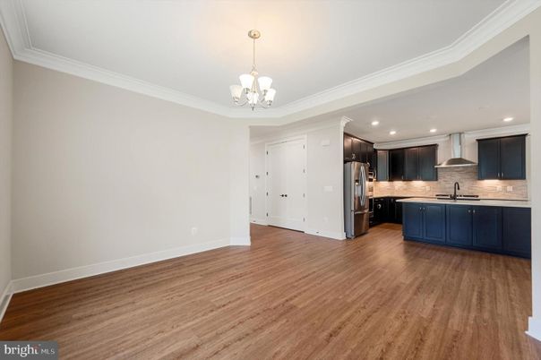 Chandelier, Empty room, Interior, Kitchen, Pendant Lights, Recessed Lighting, Stainless Steel Appliances, Wood Texture Flooring
