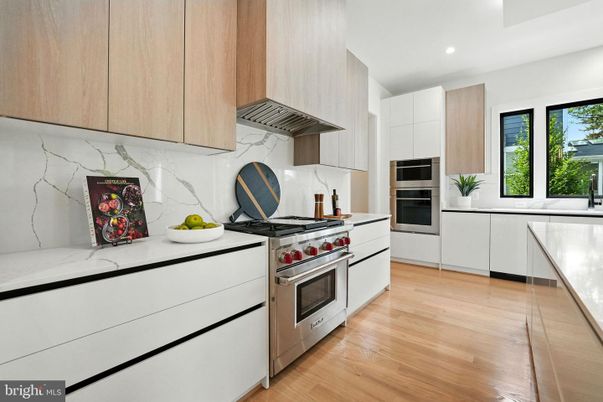 Interior, Kitchen, Marble Walls, Recessed Lighting, Stainless Steel Appliances, Wood Texture Flooring