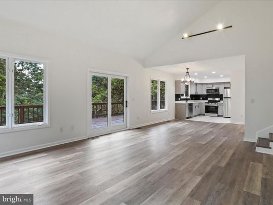 Chandelier, Empty room, Interior, Kitchen, Pendant Lights, Recessed Lighting, Stainless Steel Appliances, Wood Texture Flooring