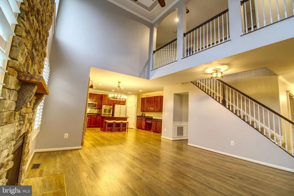 Chandelier, Fireplace, Interior, Kitchen, Recessed Lighting, Stone Walls, Wood Texture Flooring