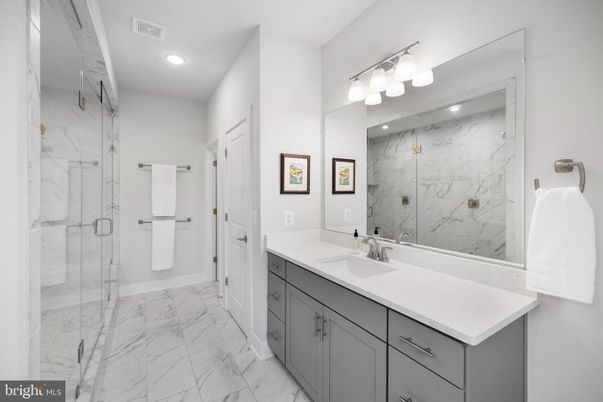 Bathroom, Dual Sink Vanities, Glass Shower, Interior, Marble, Marble Walls, Recessed Lighting