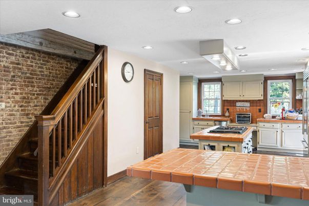 Interior, Kitchen, Recessed Lighting, Stone Walls, Tile Countertops, Wood Texture Flooring
