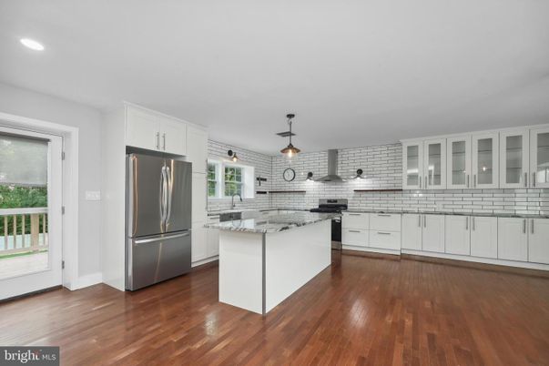 Interior, Kitchen, Pendant Lights, Recessed Lighting, Stainless Steel Appliances, Stone Walls, Wood Texture Flooring