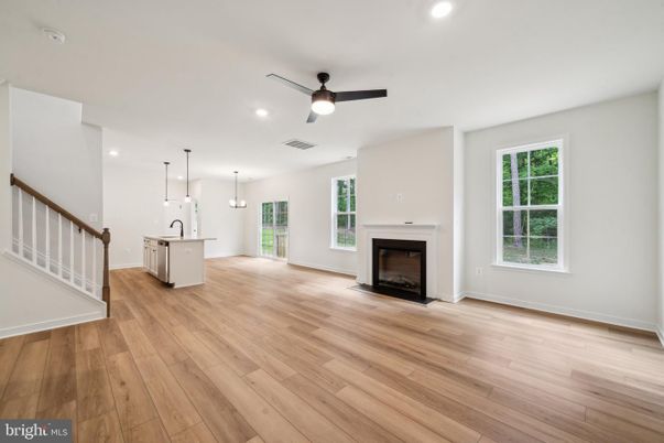 Empty room, Fireplace, Interior, Kitchen, Pendant Lights, Recessed Lighting, Wood Texture Flooring