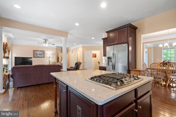 Chandelier, Dining room, Interior, Kitchen, Living room, Pendant Lights, Recessed Lighting, Stainless Steel Appliances, Wood Texture Flooring