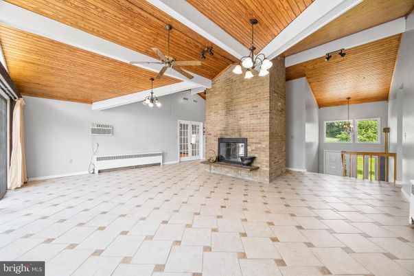 Empty room, Fireplace, Interior, Pendant Lights, Stone Walls, Wooden Ceilings