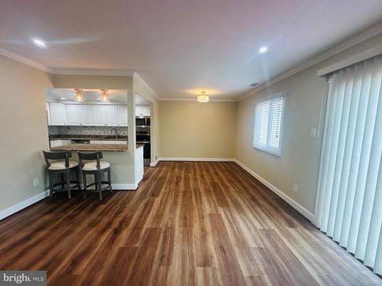 Empty room, Interior, Kitchen, Recessed Lighting, Stainless Steel Appliances, Wood Texture Flooring