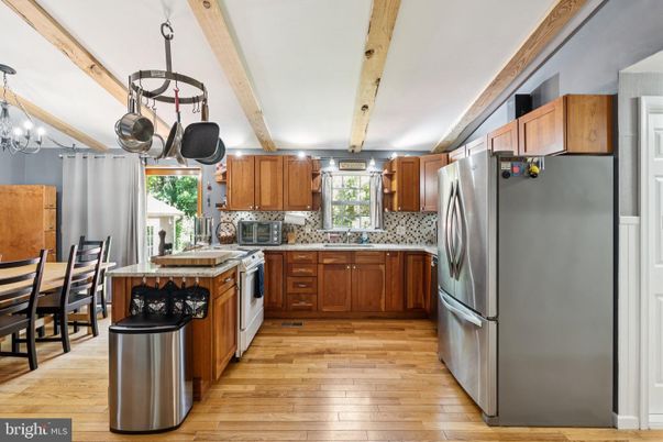 Chandelier, Dining room, Interior, Kitchen, Stainless Steel Appliances, Tile Countertops, Wooden Beams, Wood Texture Flooring