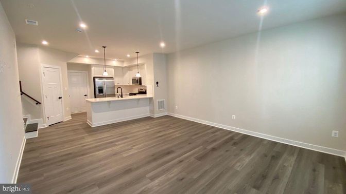 Empty room, Interior, Kitchen, Pendant Lights, Recessed Lighting, Stainless Steel Appliances, Wood Texture Flooring