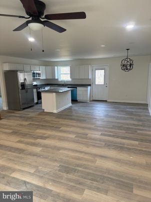 Empty room, Interior, Kitchen, Pendant Lights, Recessed Lighting, Stainless Steel Appliances, Wood Texture Flooring