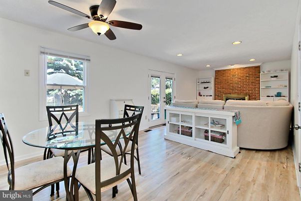 Dining room, Fireplace, Interior, Living room, Recessed Lighting, Stone Walls, Wood Texture Flooring