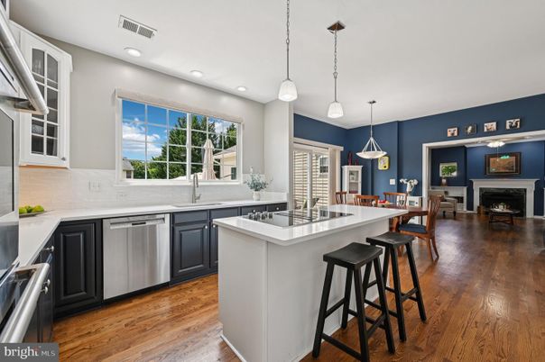 Dining room, Fireplace, Interior, Kitchen, Pendant Lights, Recessed Lighting, Stainless Steel Appliances, Wood Texture Flooring