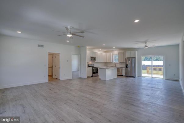 Empty room, Interior, Kitchen, Recessed Lighting, Stainless Steel Appliances, Wood Texture Flooring