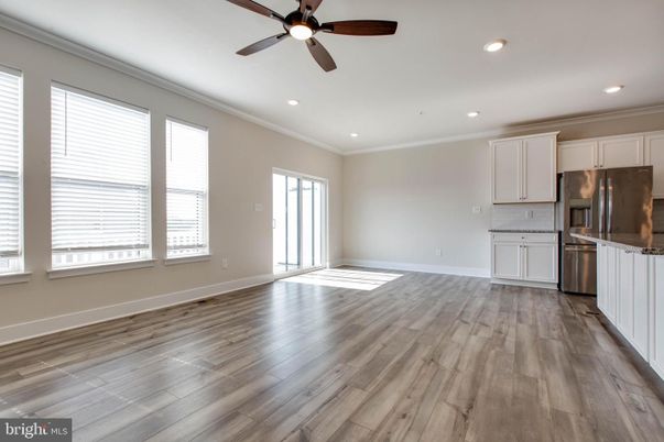 Empty room, Interior, Kitchen, Recessed Lighting, Stainless Steel Appliances, Wood Texture Flooring