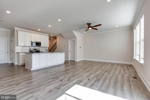 Empty room, Interior, Kitchen, Recessed Lighting, Stainless Steel Appliances, Wood Texture Flooring