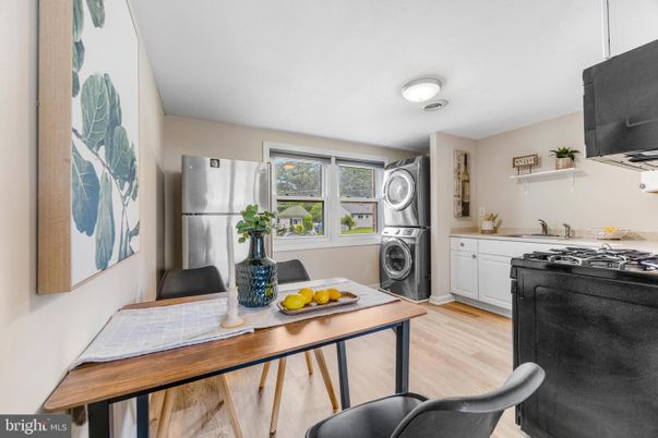 Interior, Kitchen, Tile Countertops, Washer, Wood Texture Flooring