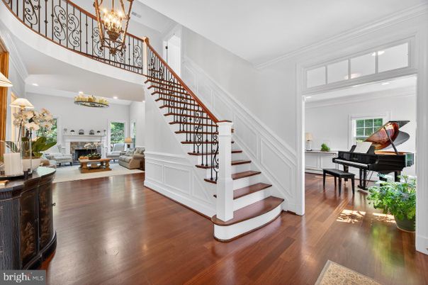 Chandelier, Fireplace, Interior, Living room, Piano, Recessed Lighting, Wood Texture Flooring