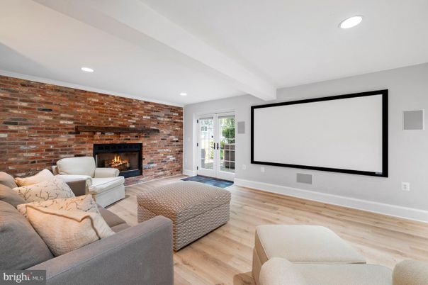 Fireplace, Interior, Living room, Projection Screen, Recessed Lighting, Stone Walls, Wood Texture Flooring