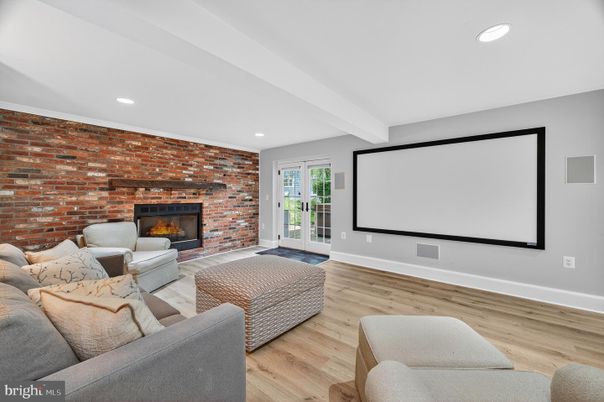 Fireplace, Interior, Living room, Projection Screen, Recessed Lighting, Stone Walls, Wood Texture Flooring