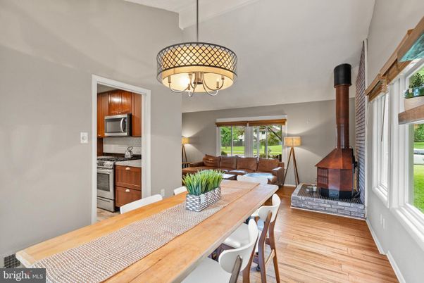 Chandelier, Dining room, Fireplace, Interior, Kitchen, Living room, Pendant Lights, Stainless Steel Appliances, Wood Texture Flooring