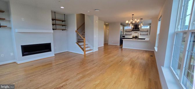 Chandelier, Empty room, Fireplace, Interior, Kitchen, Recessed Lighting, Wood Texture Flooring