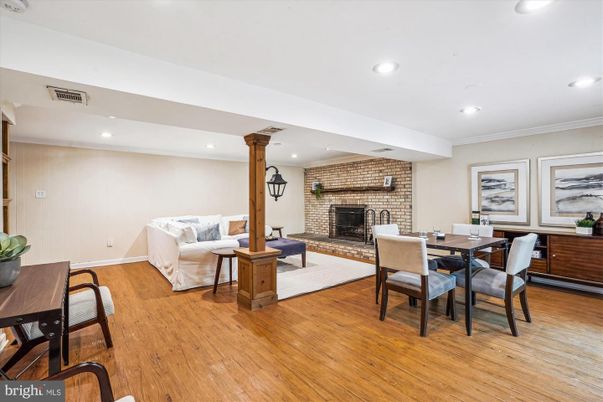 Dining room, Fireplace, Interior, Living room, Recessed Lighting, Stone Walls, Wood Texture Flooring