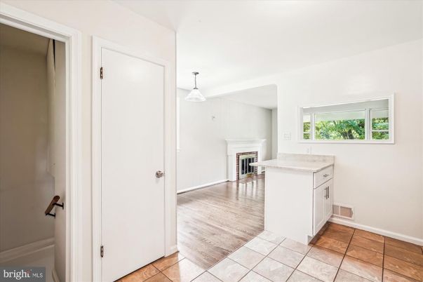 Empty room, Fireplace, Interior, Kitchen, Pendant Lights, Wood Texture Flooring