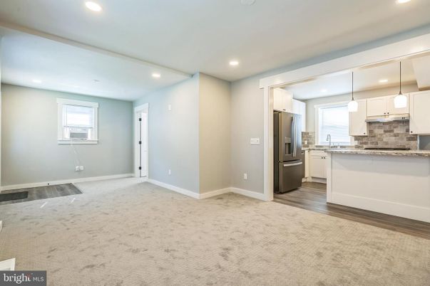 Empty room, Interior, Kitchen, Pendant Lights, Recessed Lighting, Stainless Steel Appliances, Wood Texture Flooring