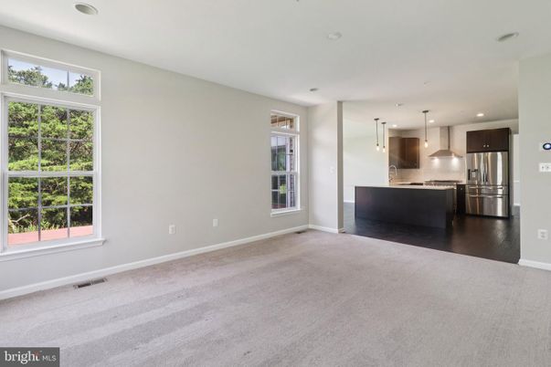 Empty room, Interior, Kitchen, Pendant Lights, Recessed Lighting, Stainless Steel Appliances, Wood Texture Flooring