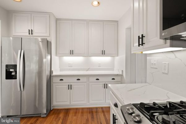 Interior, Kitchen, Marble Walls, Recessed Lighting, Stainless Steel Appliances, Wood Texture Flooring