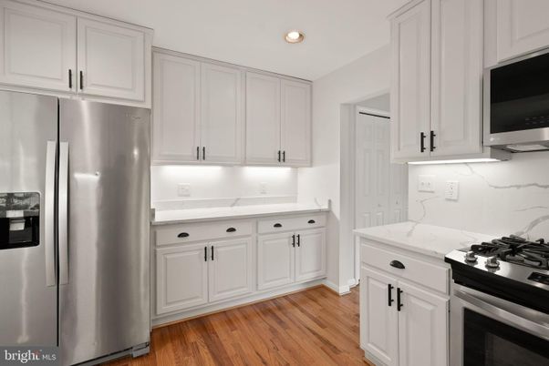 Interior, Kitchen, Marble Walls, Recessed Lighting, Stainless Steel Appliances, Wood Texture Flooring