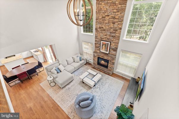 Chandelier, Dining room, Fireplace, Interior, Living room, Stone Walls, Wood Texture Flooring