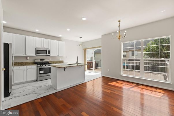 Chandelier, Interior, Kitchen, Marble, Pendant Lights, Recessed Lighting, Stainless Steel Appliances, Wood Texture Flooring