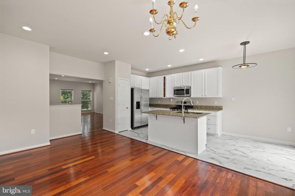 Chandelier, Interior, Kitchen, Marble, Pendant Lights, Recessed Lighting, Stainless Steel Appliances, Wood Texture Flooring