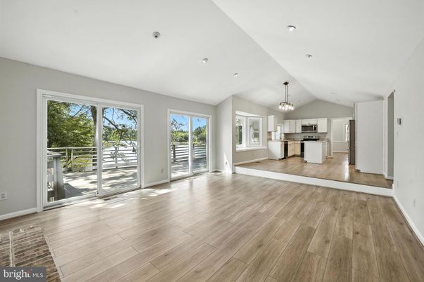 Chandelier, Empty room, Interior, Kitchen, Pendant Lights, Recessed Lighting, Stainless Steel Appliances, Wood Texture Flooring