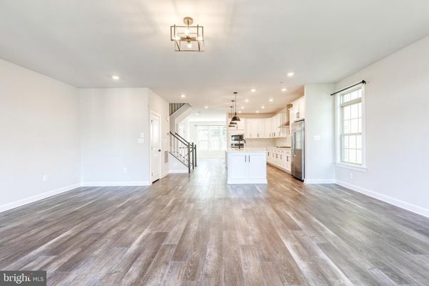 Empty room, Interior, Kitchen, Pendant Lights, Recessed Lighting, Stainless Steel Appliances, Wood Texture Flooring