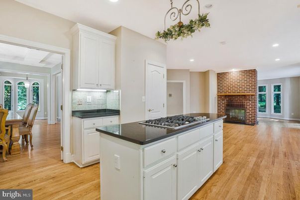 Dining room, Fireplace, Interior, Kitchen, Recessed Lighting, Stone Walls, Wood Texture Flooring