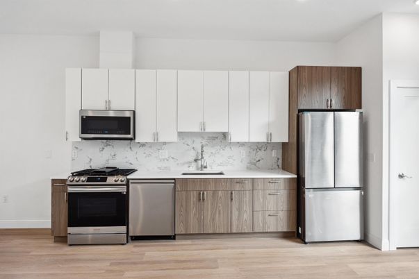 Interior, Kitchen, Marble Walls, Recessed Lighting, Stainless Steel Appliances, Wood Texture Flooring