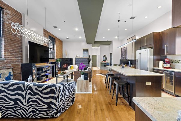 Fireplace, Interior, Kitchen, Living room, Pendant Lights, Recessed Lighting, Stainless Steel Appliances, Stone Walls, Wood Texture Flooring