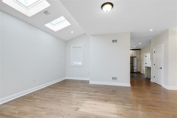 Empty room, Interior, Kitchen, Recessed Lighting, Stainless Steel Appliances, Wood Texture Flooring
