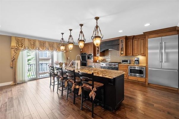 Chandelier, Dining room, Interior, Kitchen, Pendant Lights, Recessed Lighting, Stainless Steel Appliances, Wood Texture Flooring