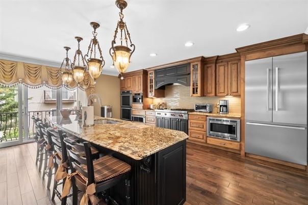 Chandelier, Dining room, Interior, Kitchen, Pendant Lights, Recessed Lighting, Stainless Steel Appliances, Wood Texture Flooring