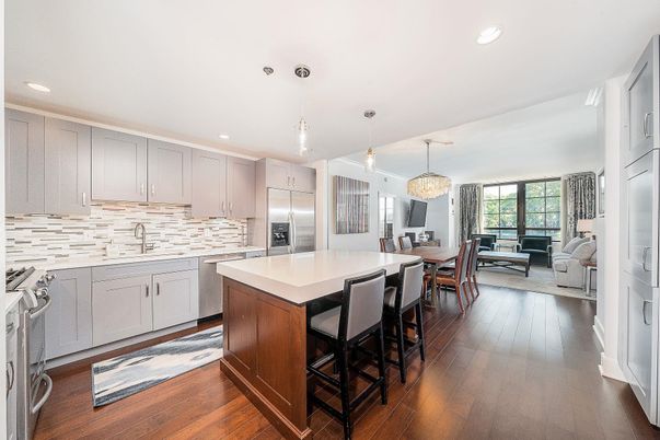 Chandelier, Dining room, Interior, Kitchen, Living room, Pendant Lights, Recessed Lighting, Stainless Steel Appliances, Wood Texture Flooring