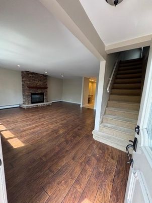 Empty room, Fireplace, Interior, Recessed Lighting, Stone Walls, Wood Texture Flooring